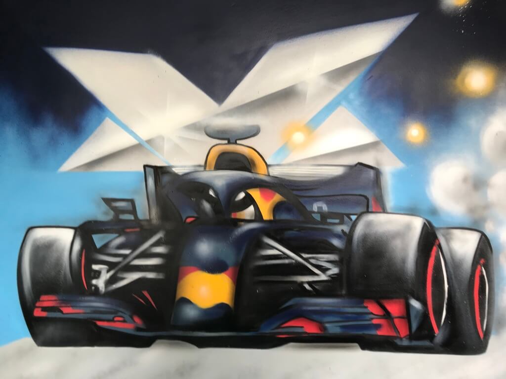 A friend of Theron's asks if he can spray-paint Max Verstappen's car on his son's bedroom wall. Theron honestly admits that he has never painted such intricate details before and proposes using a projector. His buddy manages to get one, and Theron gets to work with enthusiasm and energy.
The reaction when it was done: "We're stoked about it! It turned out super awesome." Thankfully, the paint smell quickly dissipated, allowing the little dude to enter his rad new room in no time.