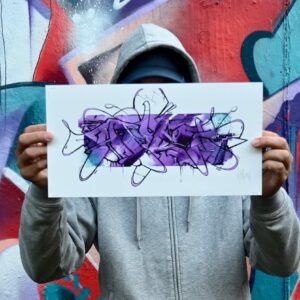 Theron holding a print Purple Paint